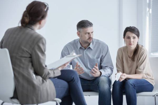 Family therapist during meeting with unhappy, married couple